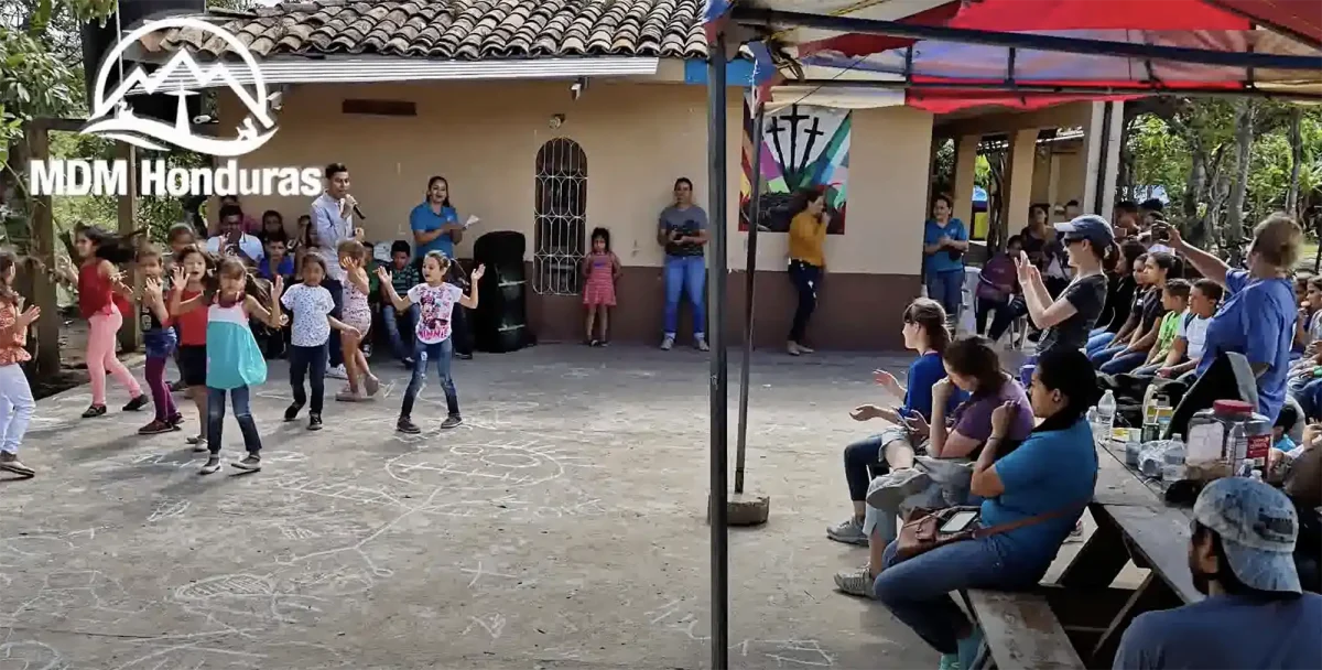 children performing in front of audience outdoors