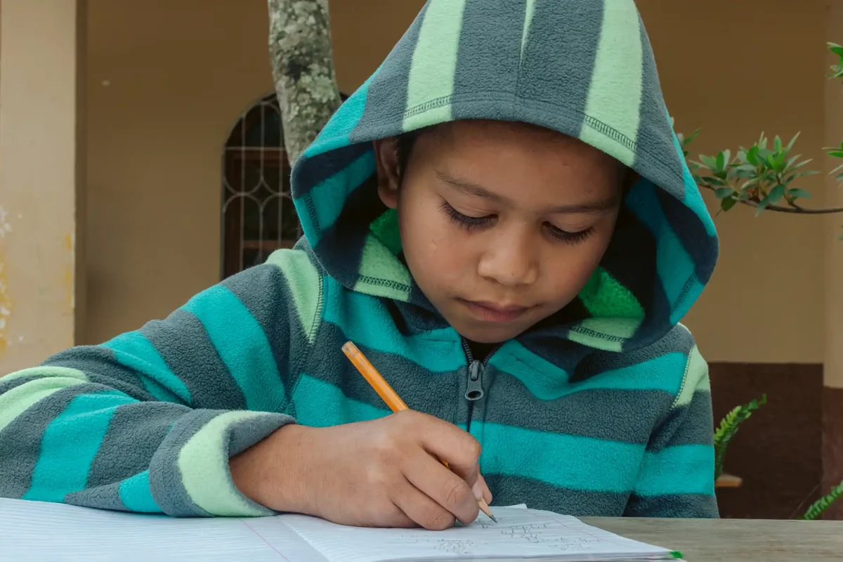 Elementary student busy writing