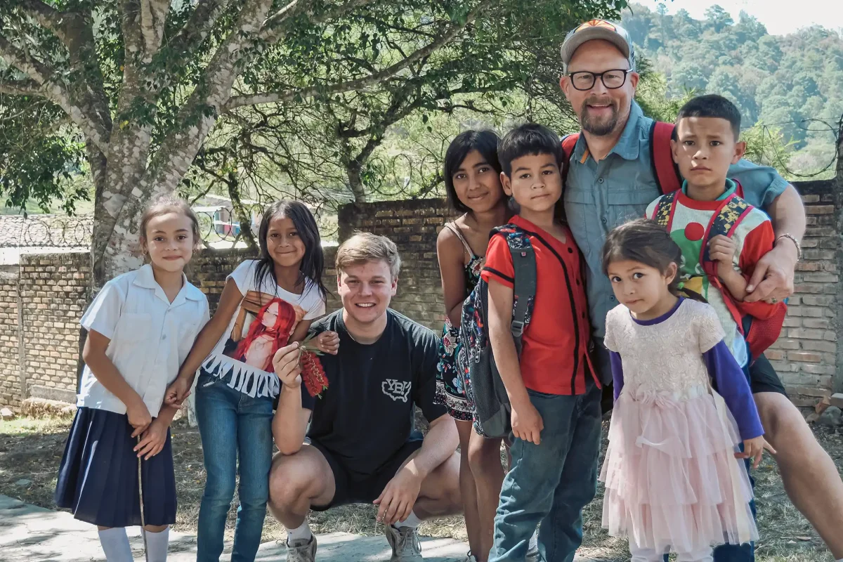 mission team members with group of young students