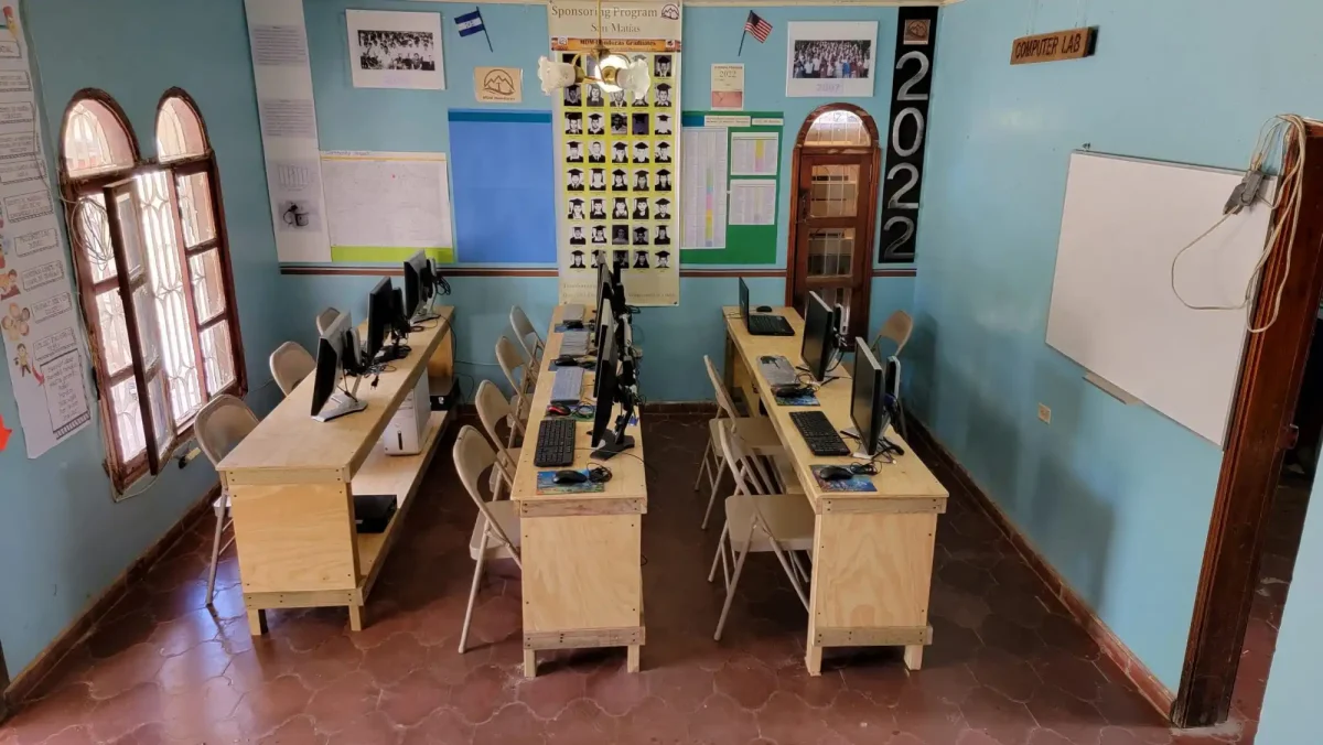 empty classroom with desks and computers