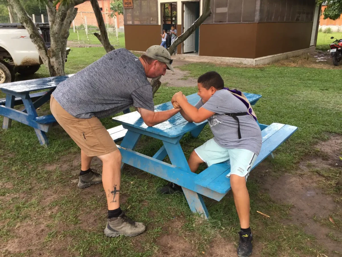 Bill Roy arm wrestling with teenager