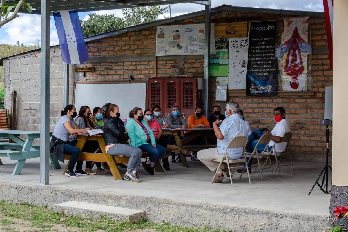 group of parents listening to speaker outside