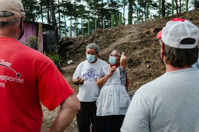 mission team members talking with community members