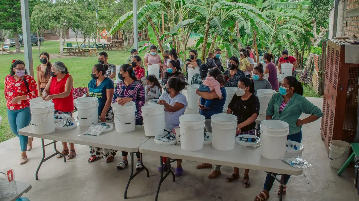 villagers learning how to use water filtration kits