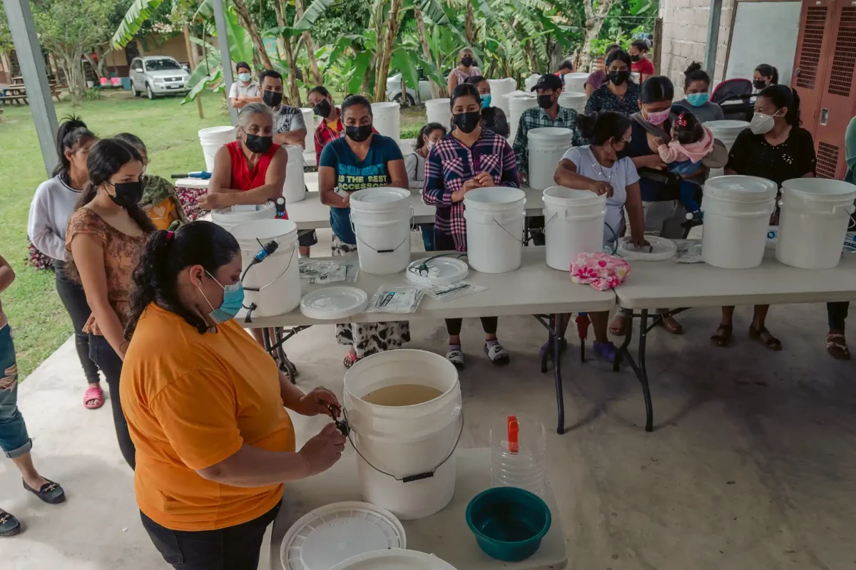 villagers watching demonstration of clean water kit