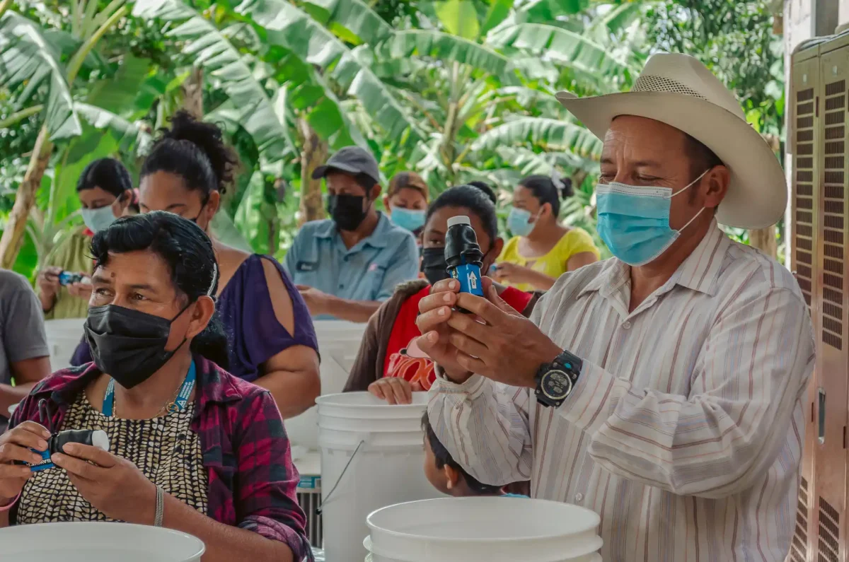 group of people putting together clean water kits