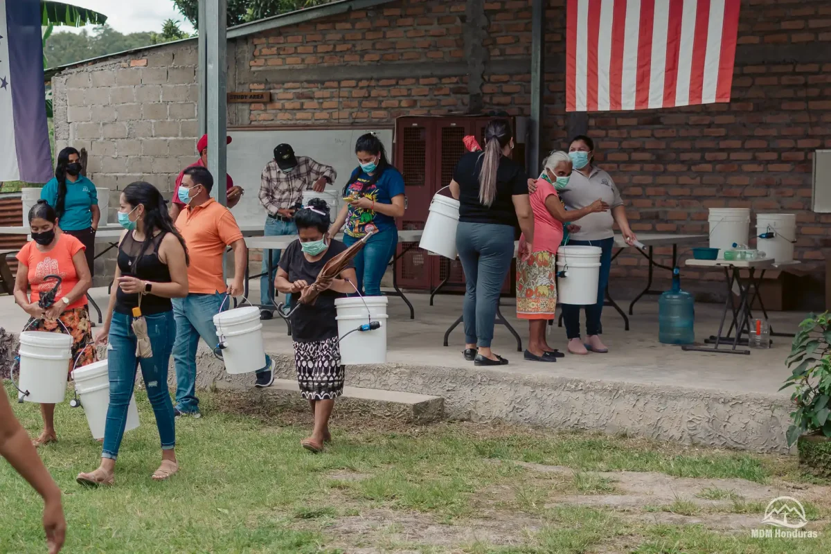 villagers leaving clean water training with their new water filtration kits