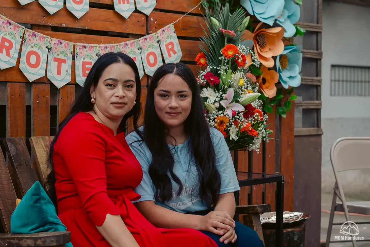 2 women sitting down for picture