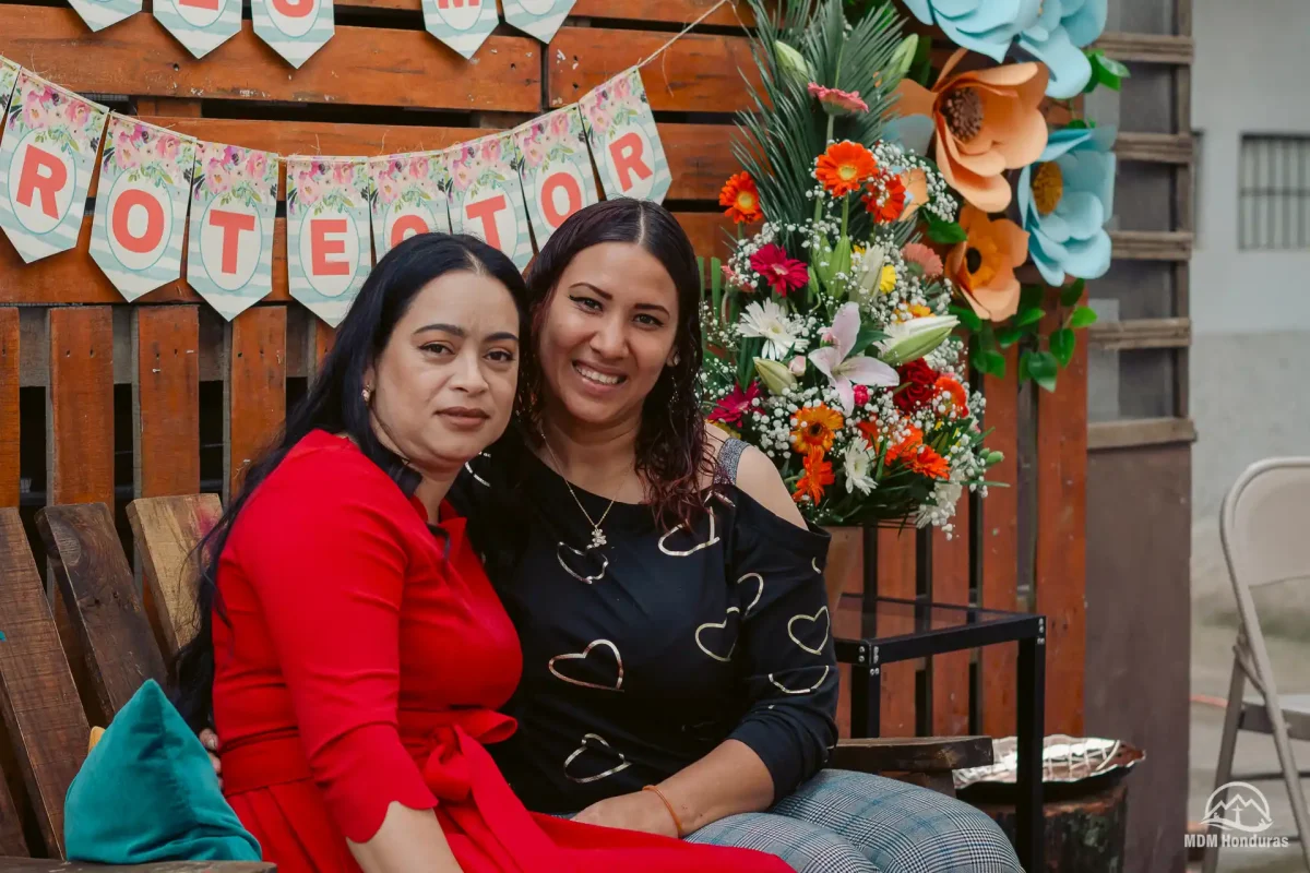 2 women sitting down for picture