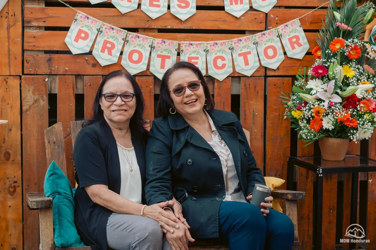 2 women sitting down for picture