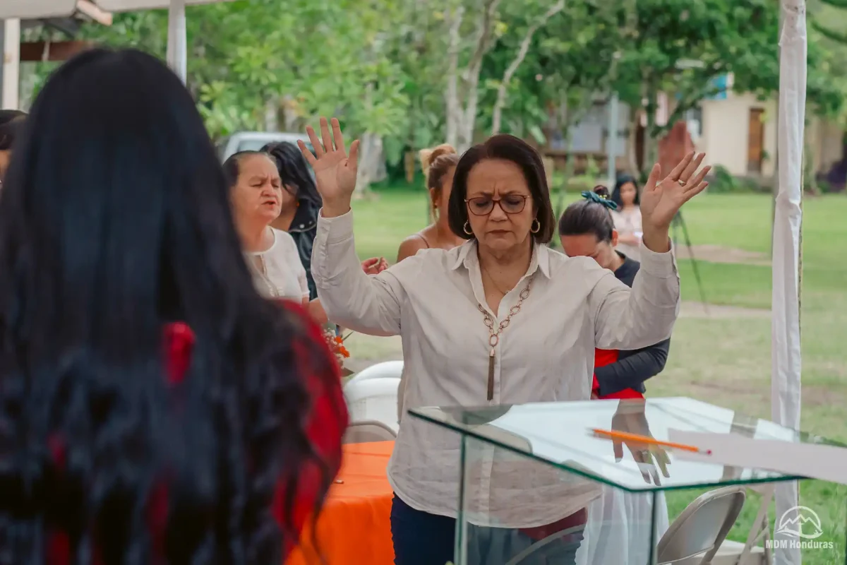 woman with hands raised in worship