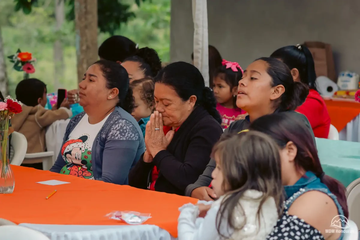 Women at conference praying