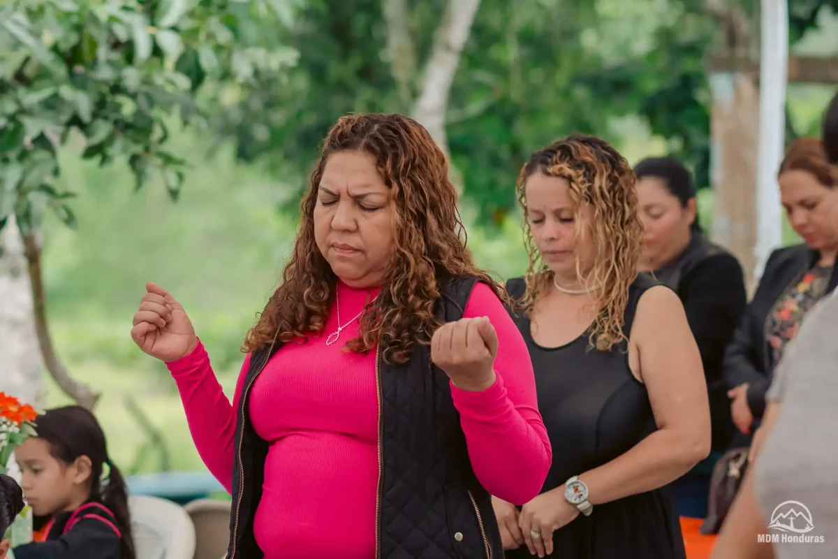 Women in audience praying