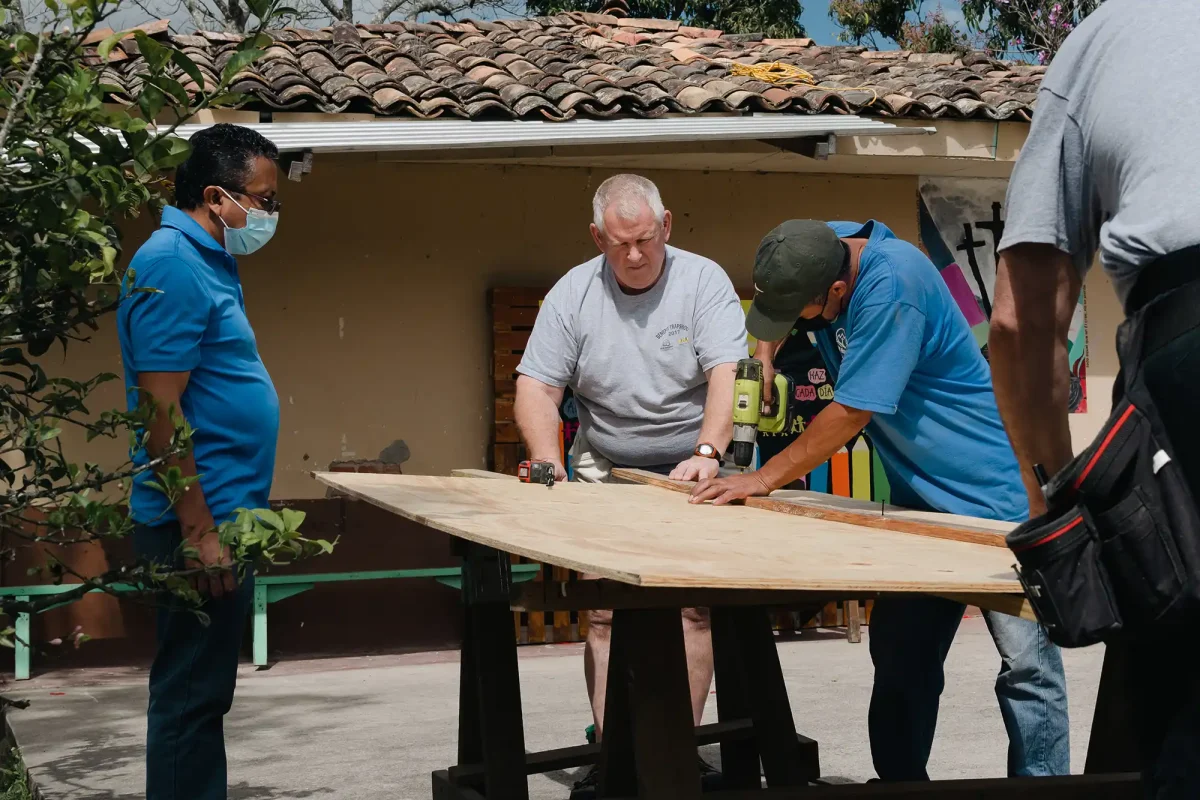 construction team members cutting plywood