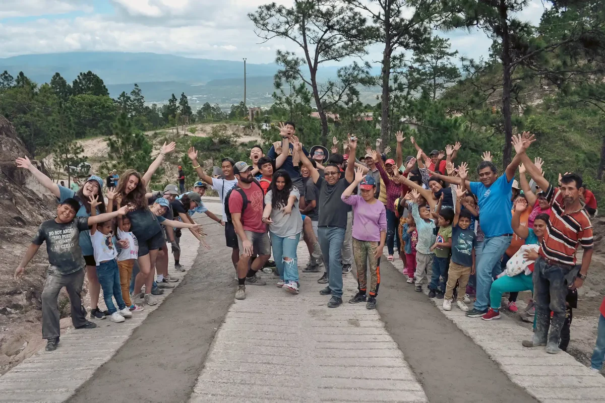 mission team and community members celebrate road building project