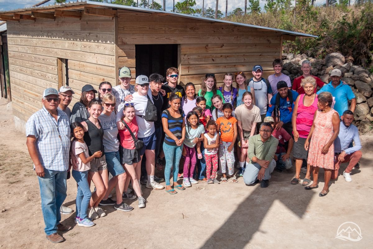 Mission team and volunteers in front of a new house