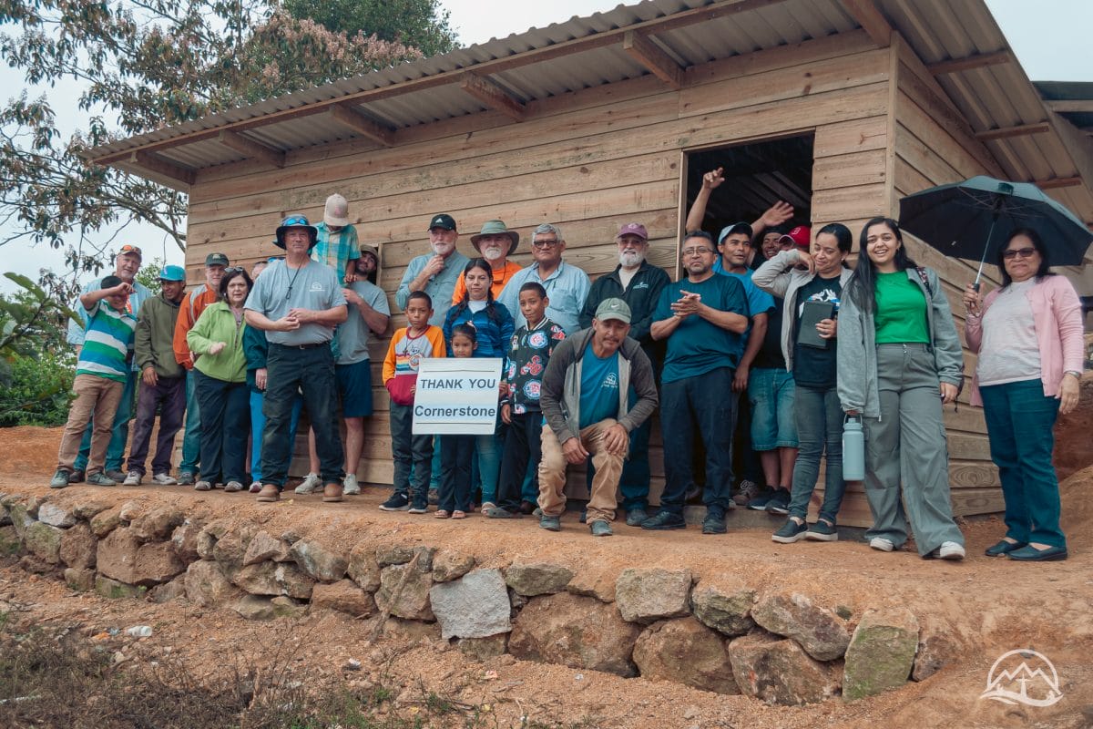 Mission team and volunteers in front of a new house